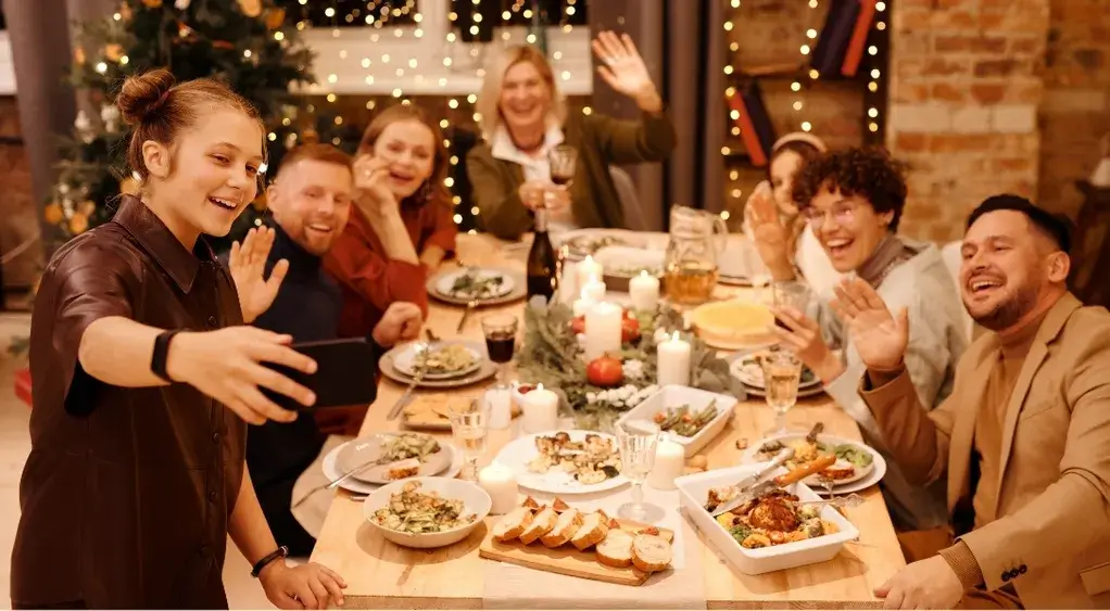 Happy family celebrating Thanksgiving around a festive dinner table with warm lights and smiles