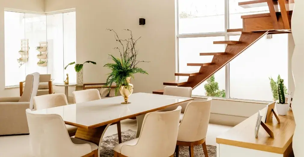 Bright and spotless dining room with large windows, modern furniture, and a clean interior.