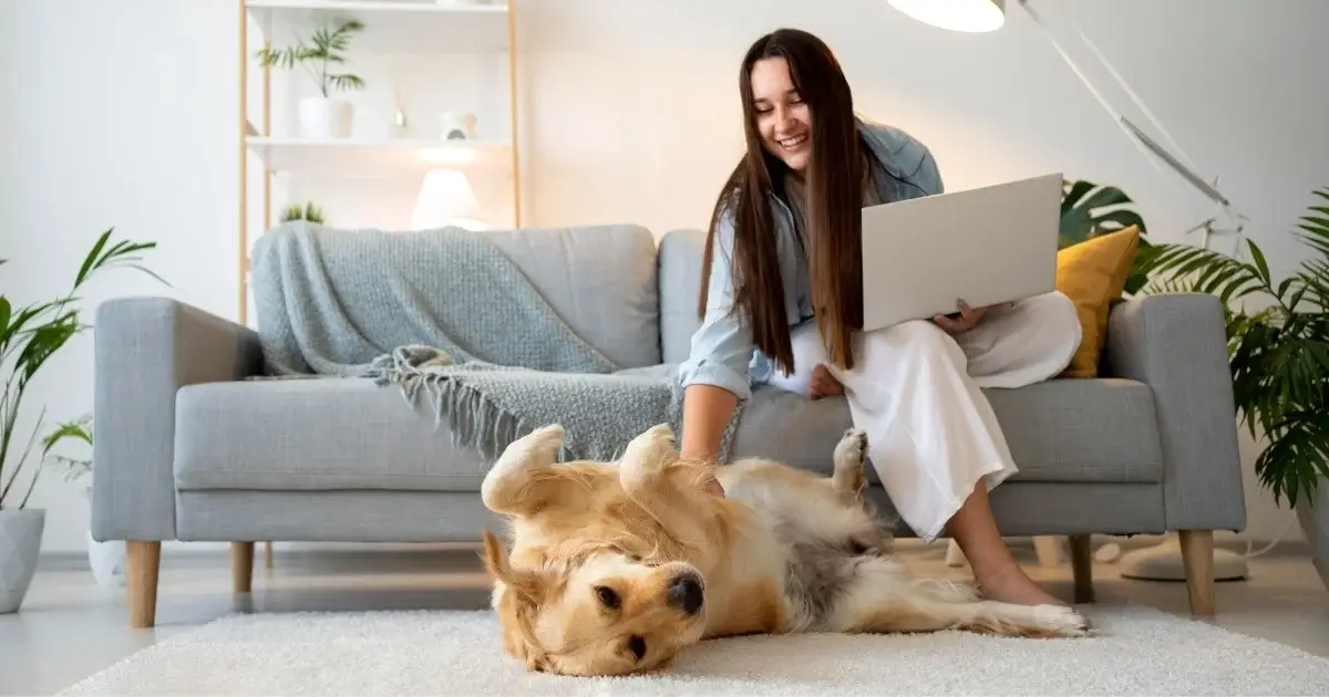 Cleaning tips for homes with pets featuring a woman relaxing with her dog in a clean living room